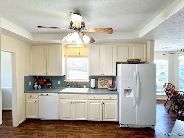 kitchen featuring white appliances, a ceiling fan, a sink, a textured ceiling, and dark wood-style floors