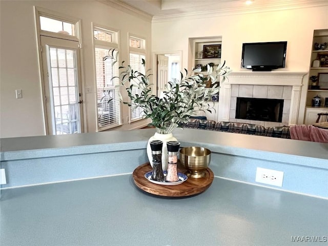 detailed view of crown molding and a tile fireplace