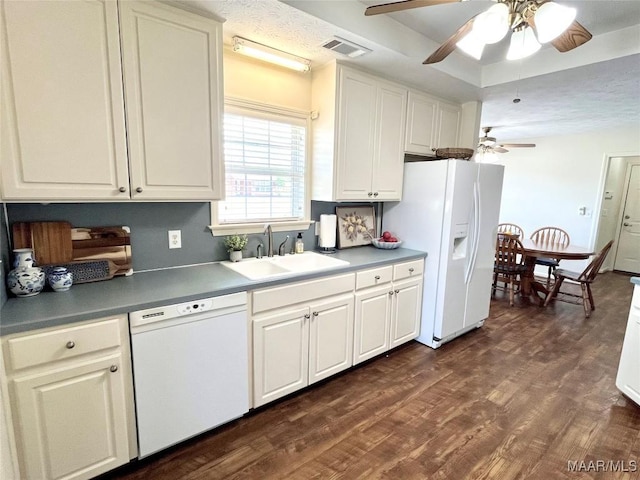 kitchen featuring white appliances, a sink, ceiling fan, dark wood finished floors, and white cabinetry