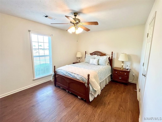 bedroom with dark wood-style flooring, baseboards, and a ceiling fan