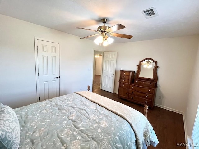 bedroom with wood finished floors, baseboards, and a ceiling fan