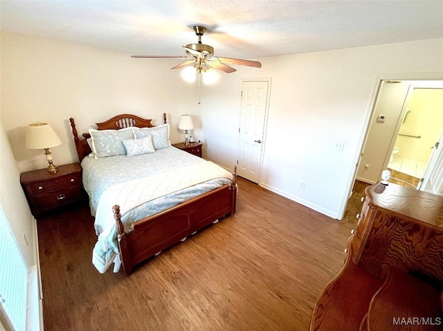 bedroom with wood finished floors, baseboards, and a ceiling fan