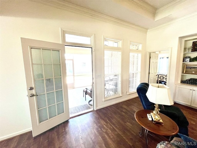 entryway with crown molding, dark wood-style floors, and built in features