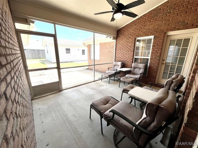 sunroom featuring ceiling fan and lofted ceiling
