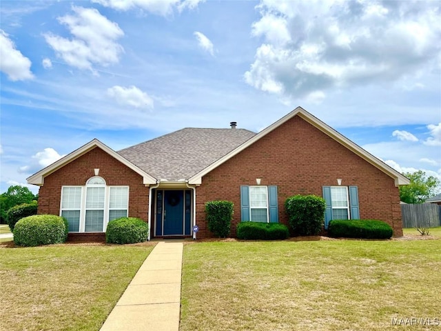 view of front facade featuring brick siding and roof with shingles
