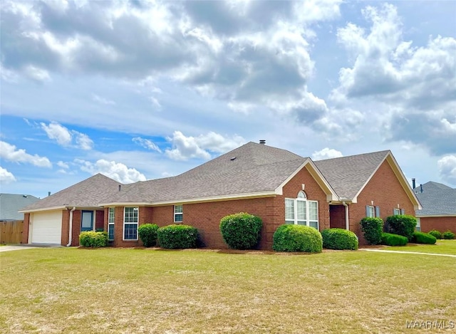 ranch-style house with brick siding, a garage, a front yard, and roof with shingles
