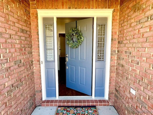property entrance with brick siding