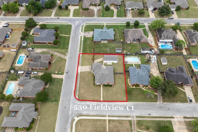 aerial view of residential area featuring a pool area and property boundaries highlighted