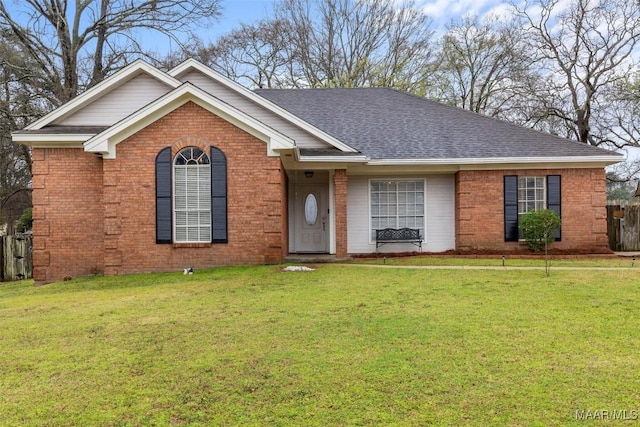 single story home with brick siding, a front yard, and roof with shingles