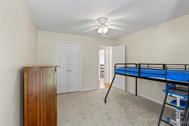 bedroom with carpet flooring, baseboards, a closet, and ceiling fan