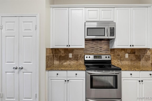 kitchen with white cabinets, backsplash, and appliances with stainless steel finishes