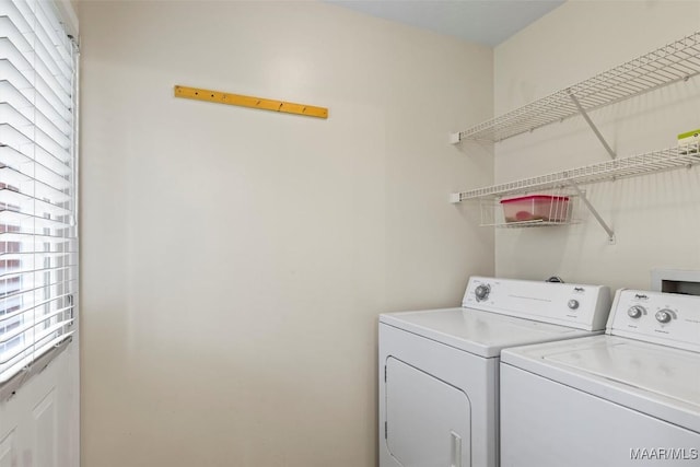 laundry area featuring a wealth of natural light, laundry area, and washer and dryer