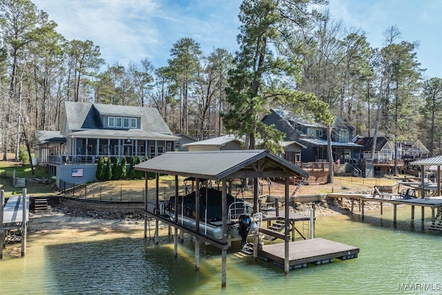 dock area featuring boat lift and a water view