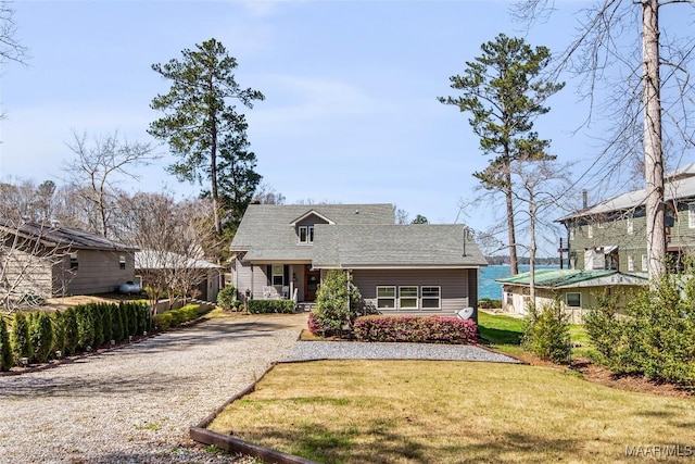 view of front of home featuring driveway and a front lawn