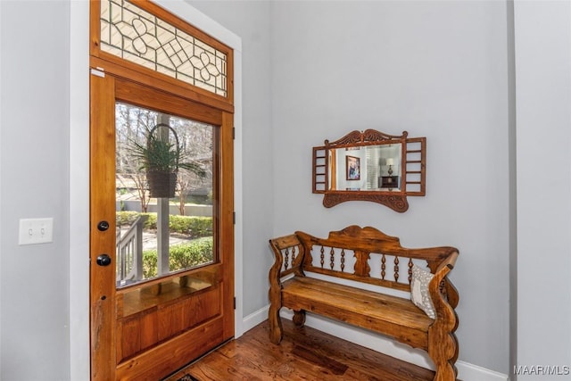 foyer entrance with baseboards and wood finished floors