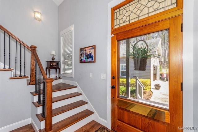 entrance foyer featuring stairs, wood finished floors, and baseboards