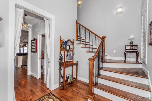 stairs featuring baseboards and wood finished floors