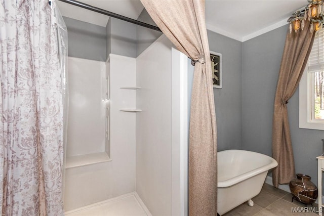 bathroom with tile patterned flooring, a soaking tub, and a shower with curtain