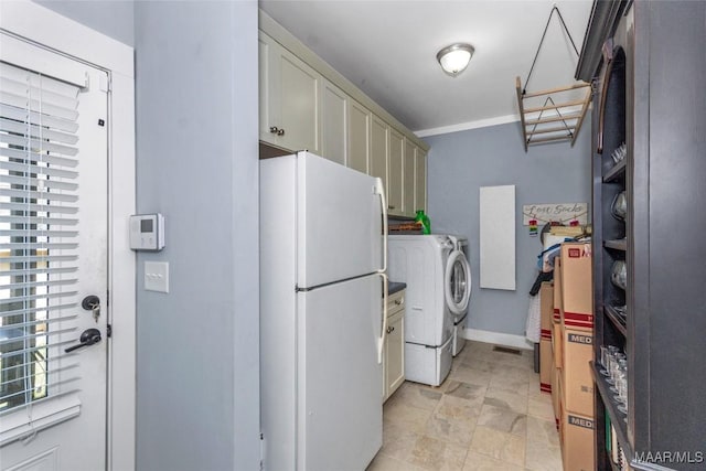 laundry room with cabinet space, baseboards, and separate washer and dryer