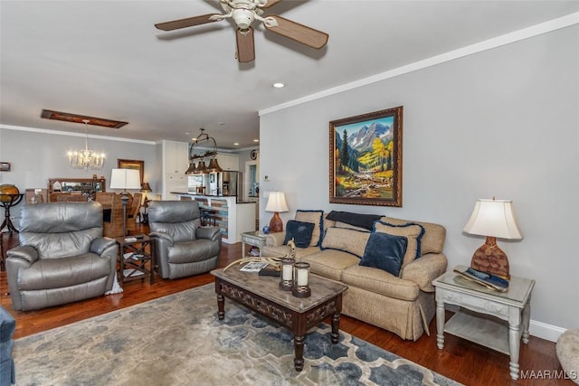 living room with ceiling fan with notable chandelier, wood finished floors, recessed lighting, crown molding, and baseboards