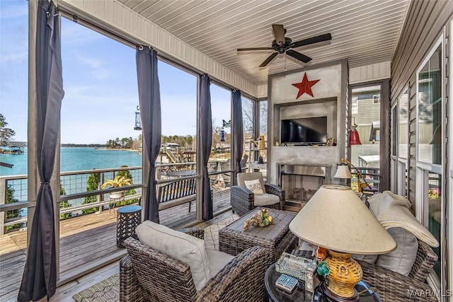 sunroom / solarium featuring ceiling fan