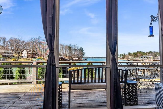 wooden deck featuring a water view