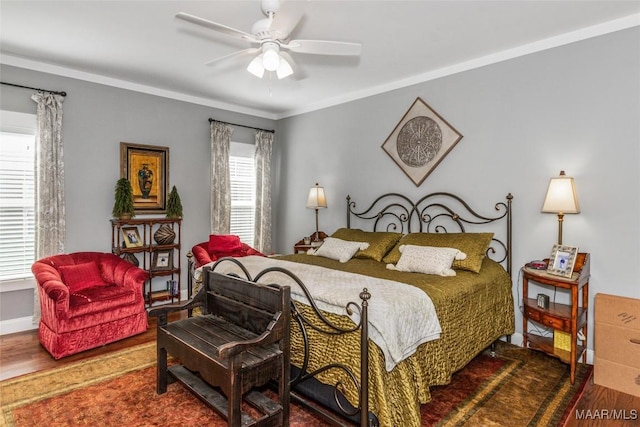 bedroom featuring ornamental molding, a ceiling fan, baseboards, and wood finished floors