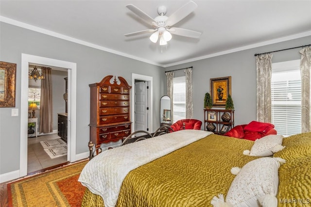 bedroom featuring ceiling fan, ensuite bathroom, baseboards, and ornamental molding