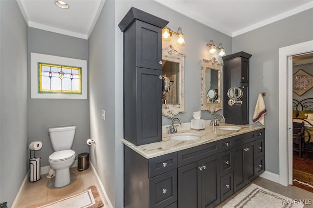 full bathroom featuring tile patterned floors, double vanity, toilet, and a sink