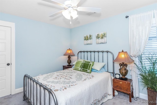 carpeted bedroom featuring baseboards and ceiling fan