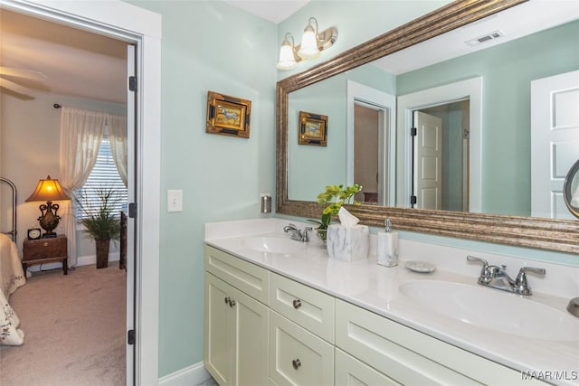 full bathroom featuring double vanity, visible vents, baseboards, and a sink