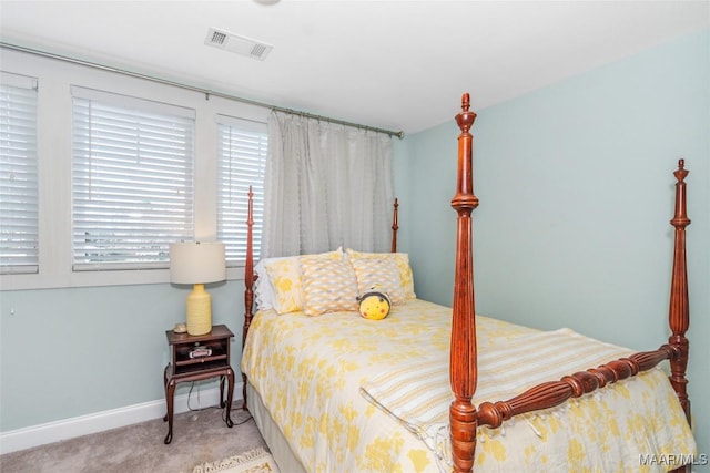 carpeted bedroom featuring visible vents and baseboards