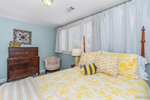 bedroom featuring visible vents and baseboards