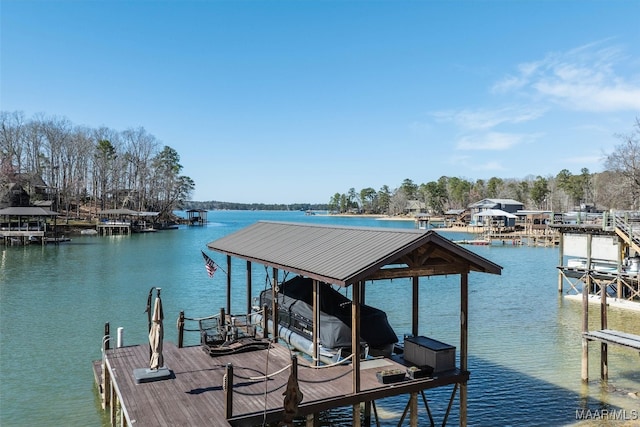 dock area with boat lift and a water view