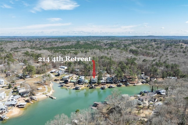 aerial view with a water view and a wooded view