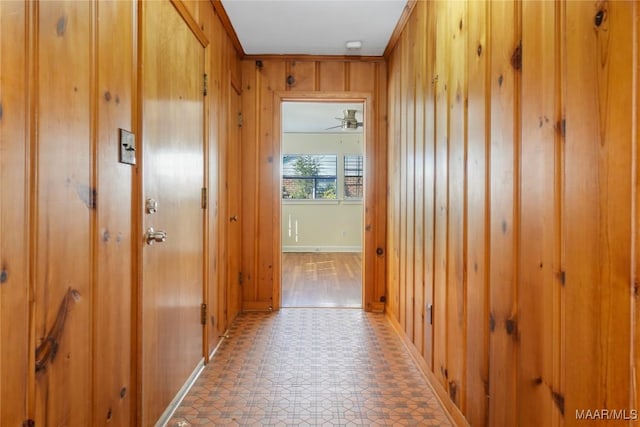 corridor with wood walls and light floors