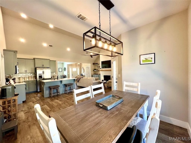 dining space featuring visible vents, baseboards, and dark wood-type flooring