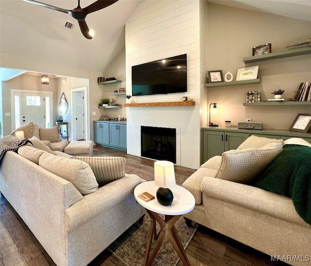 living room featuring visible vents, high vaulted ceiling, a ceiling fan, dark wood-style floors, and a fireplace