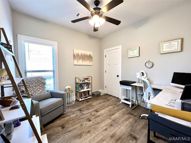 home office featuring visible vents, baseboards, ceiling fan, and wood finished floors