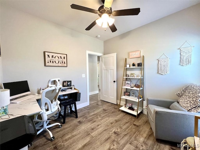 office space featuring wood finished floors, baseboards, and ceiling fan