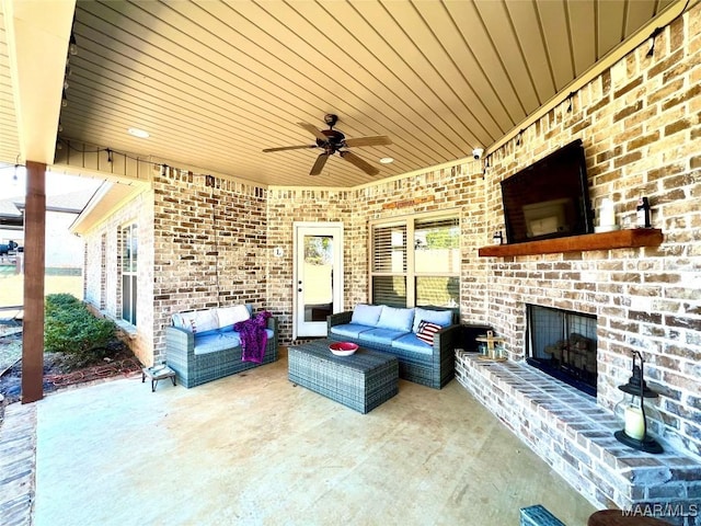 view of patio / terrace featuring an outdoor living space with a fireplace and ceiling fan