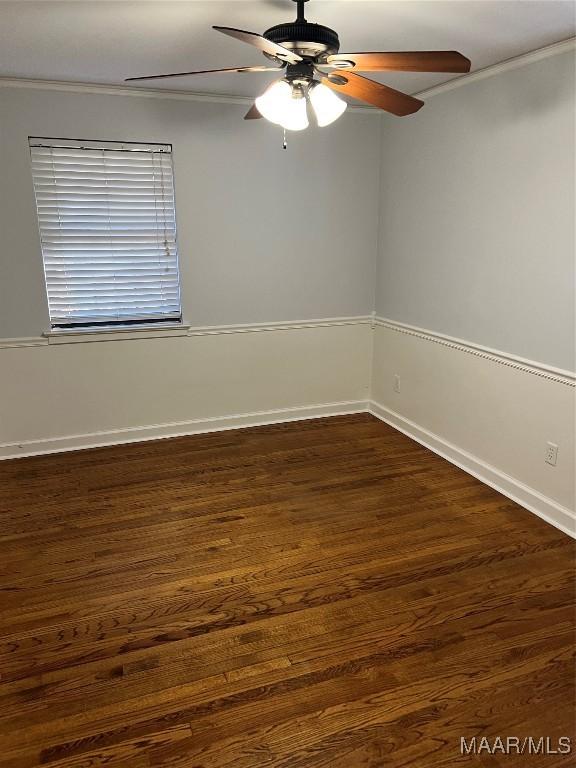 spare room with ceiling fan, baseboards, and dark wood-style floors