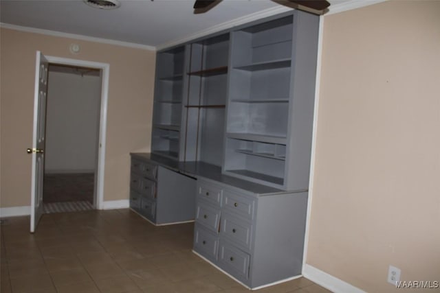 unfurnished office with tile patterned floors, baseboards, and crown molding