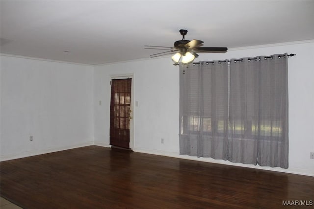 empty room featuring ornamental molding, baseboards, ceiling fan, and wood finished floors