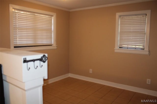 unfurnished room featuring tile patterned flooring, baseboards, and ornamental molding