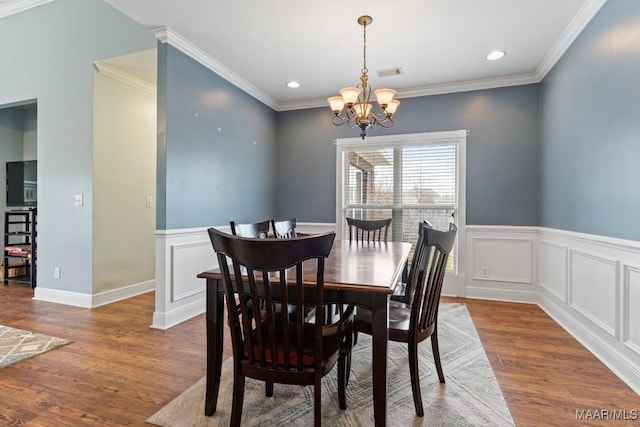 dining area with visible vents, crown molding, recessed lighting, wood finished floors, and a notable chandelier