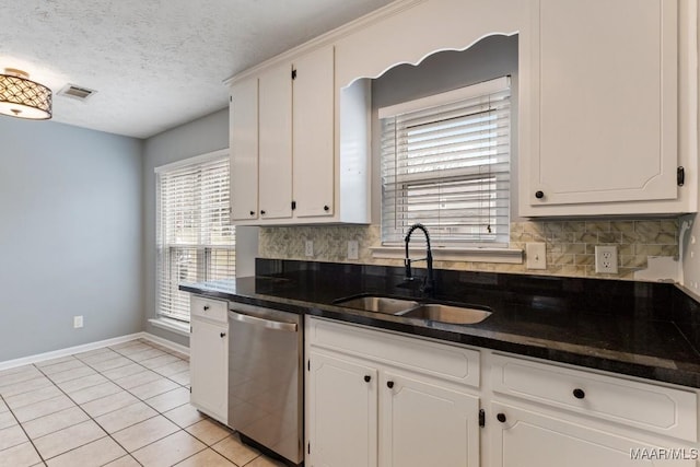 kitchen featuring dishwasher, visible vents, white cabinetry, and a sink