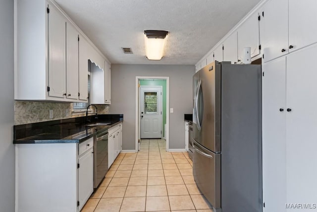 kitchen with a sink, decorative backsplash, white cabinetry, and stainless steel appliances