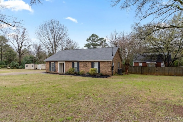 single story home featuring a front yard, central air condition unit, fence, and brick siding