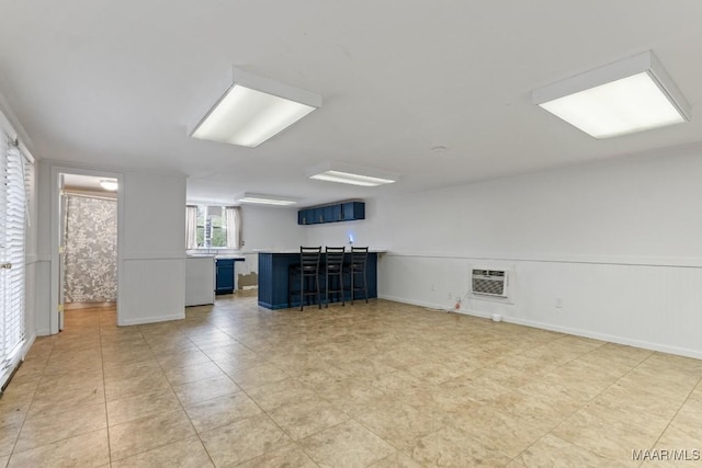 interior space featuring wainscoting and a bar